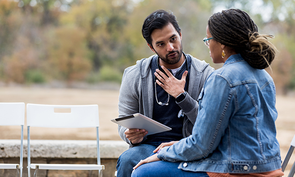 community health nurse talking to patient in park