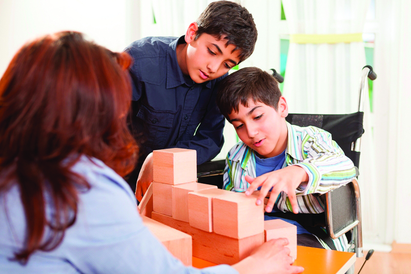 two young boys playing with blocks