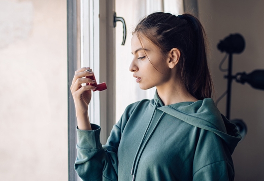 young woman with an asthma inhaler