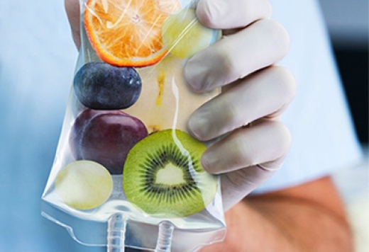 healthcare professional holding bag of fruits