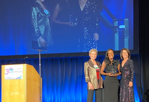 people on stage holding award