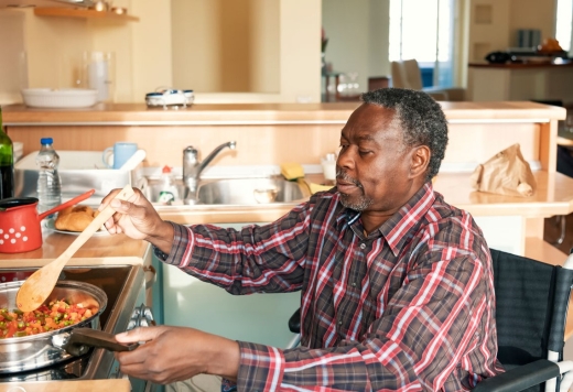 African American man in wheelchair cooking